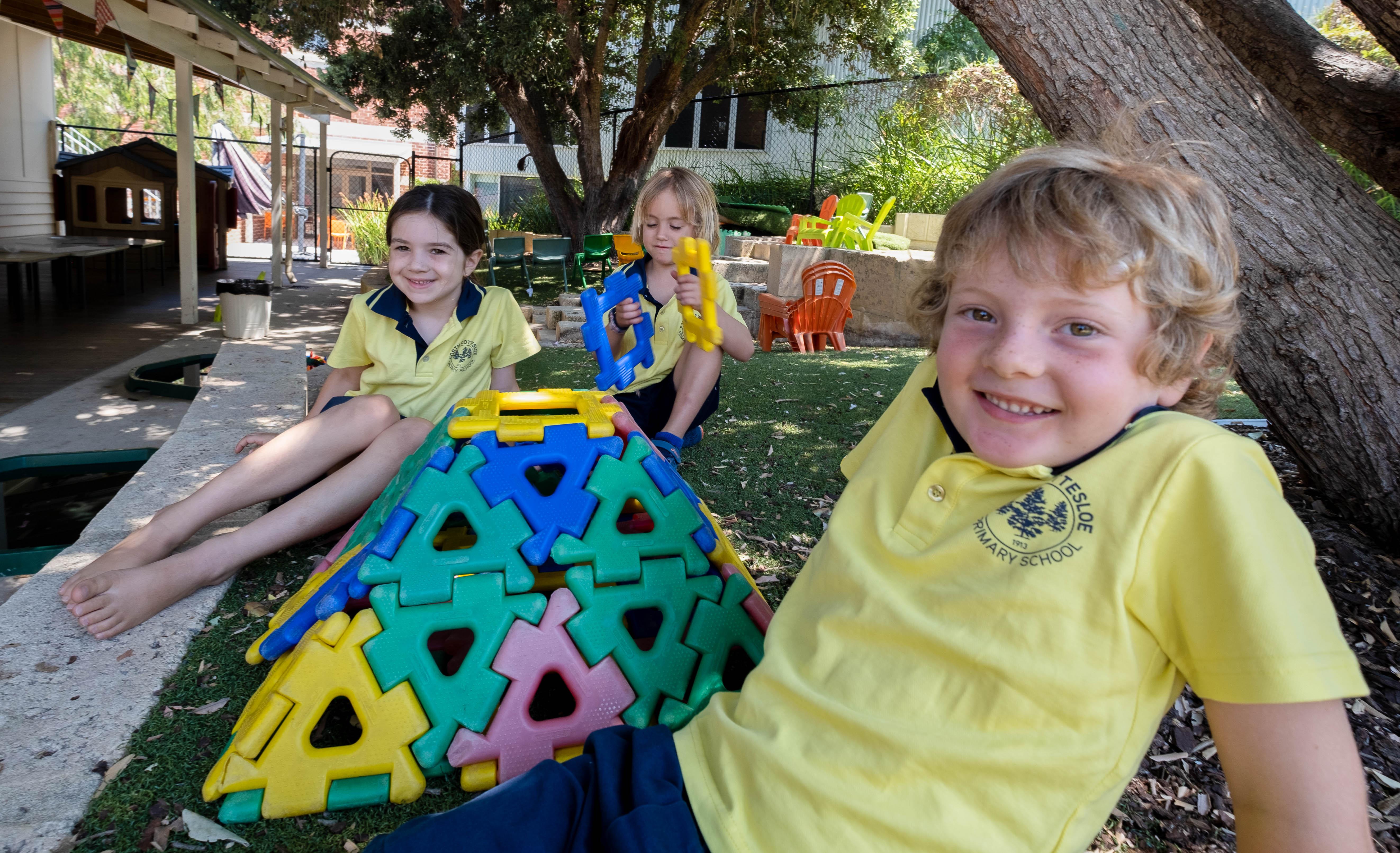 Students playing with construction blocks in the playground